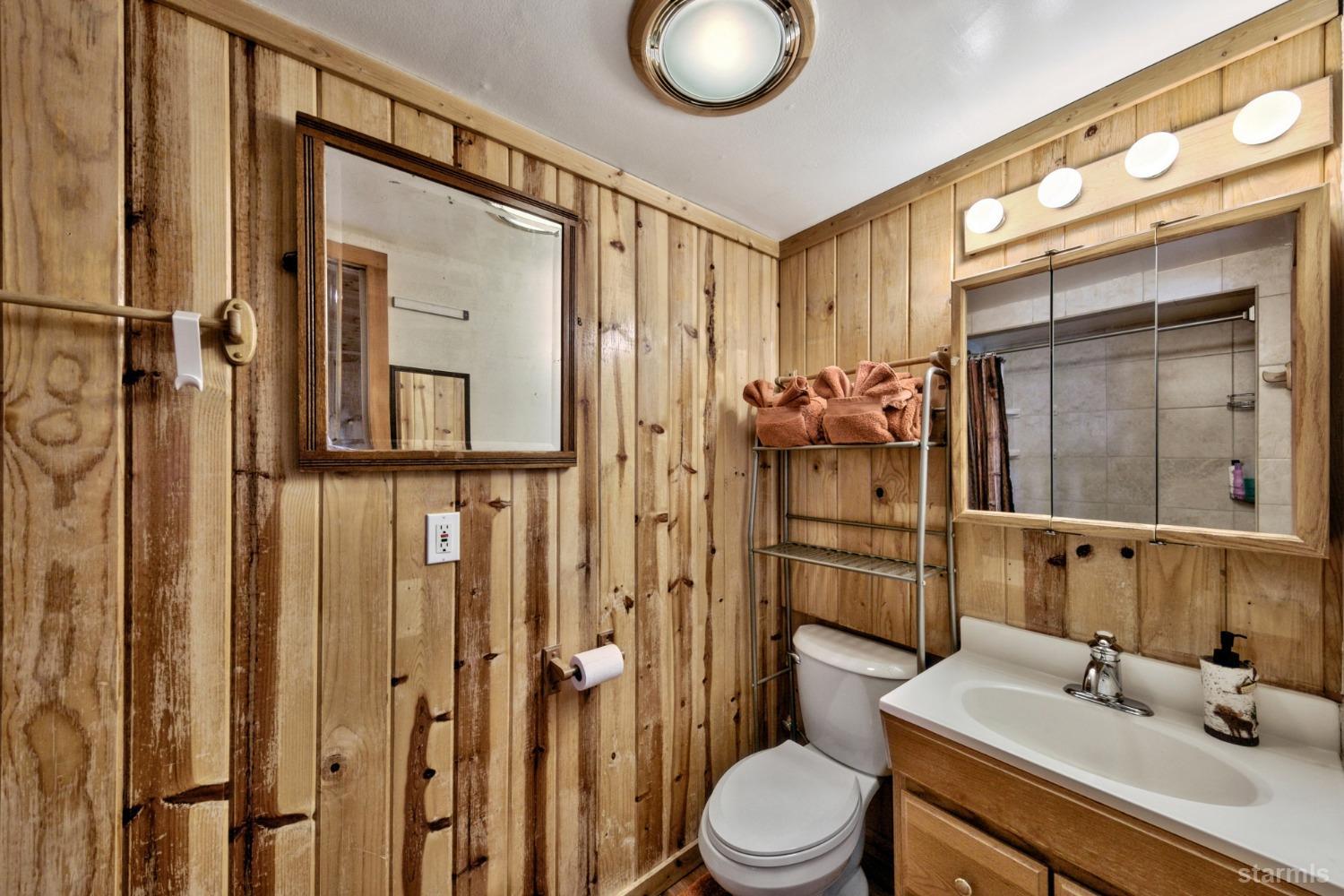 3865 Beach Road South Lake Tahoe, CA 96150 - Photo 22 of 35 a bathroom with a sink a toilet and shower