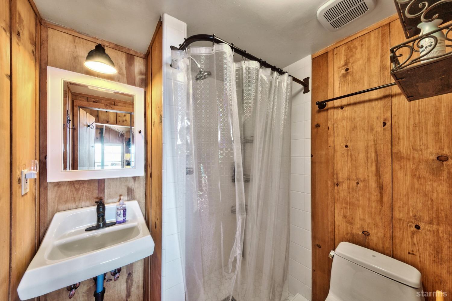 3865 Beach Road South Lake Tahoe, CA 96150 - Photo 27 of 35 a bathroom with a shower curtain and a sink