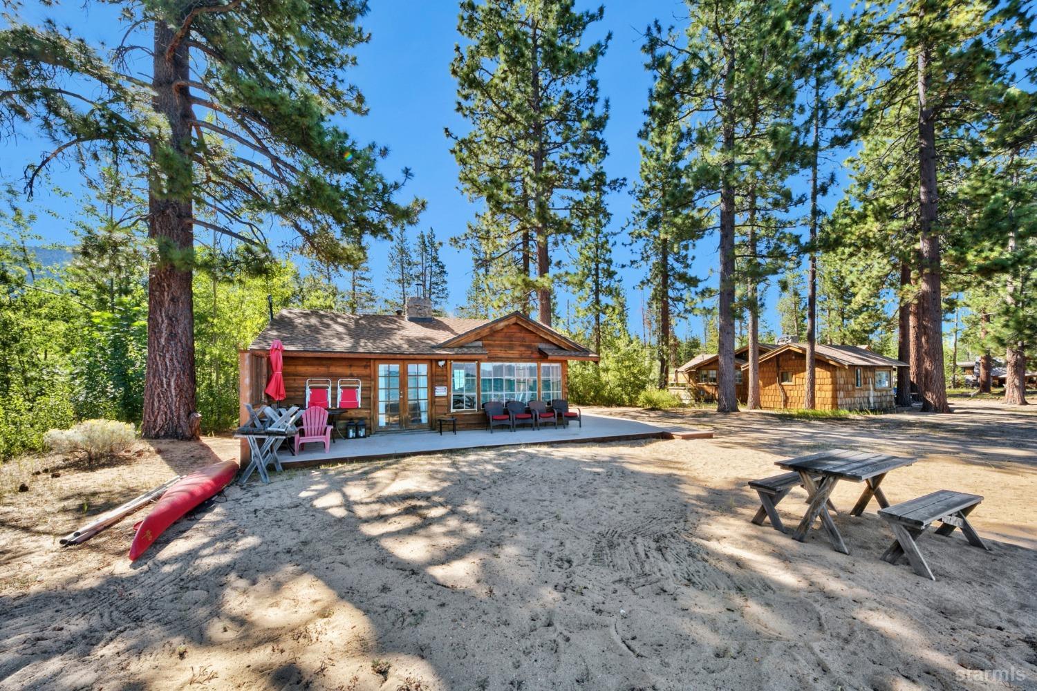 3865 Beach Road South Lake Tahoe, CA 96150 - Photo 8 of 35 a front view of a house with a yard and trees
