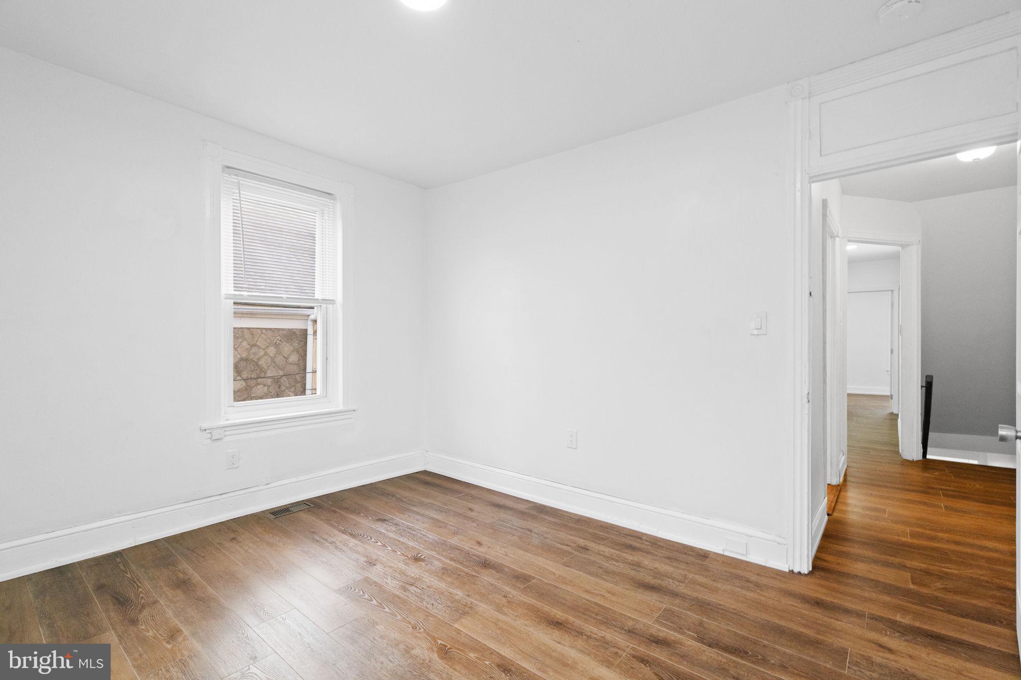 620 George Street Norristown, PA 19401 - Photo 26 of 53 a view of an empty room with wooden floor and a window
