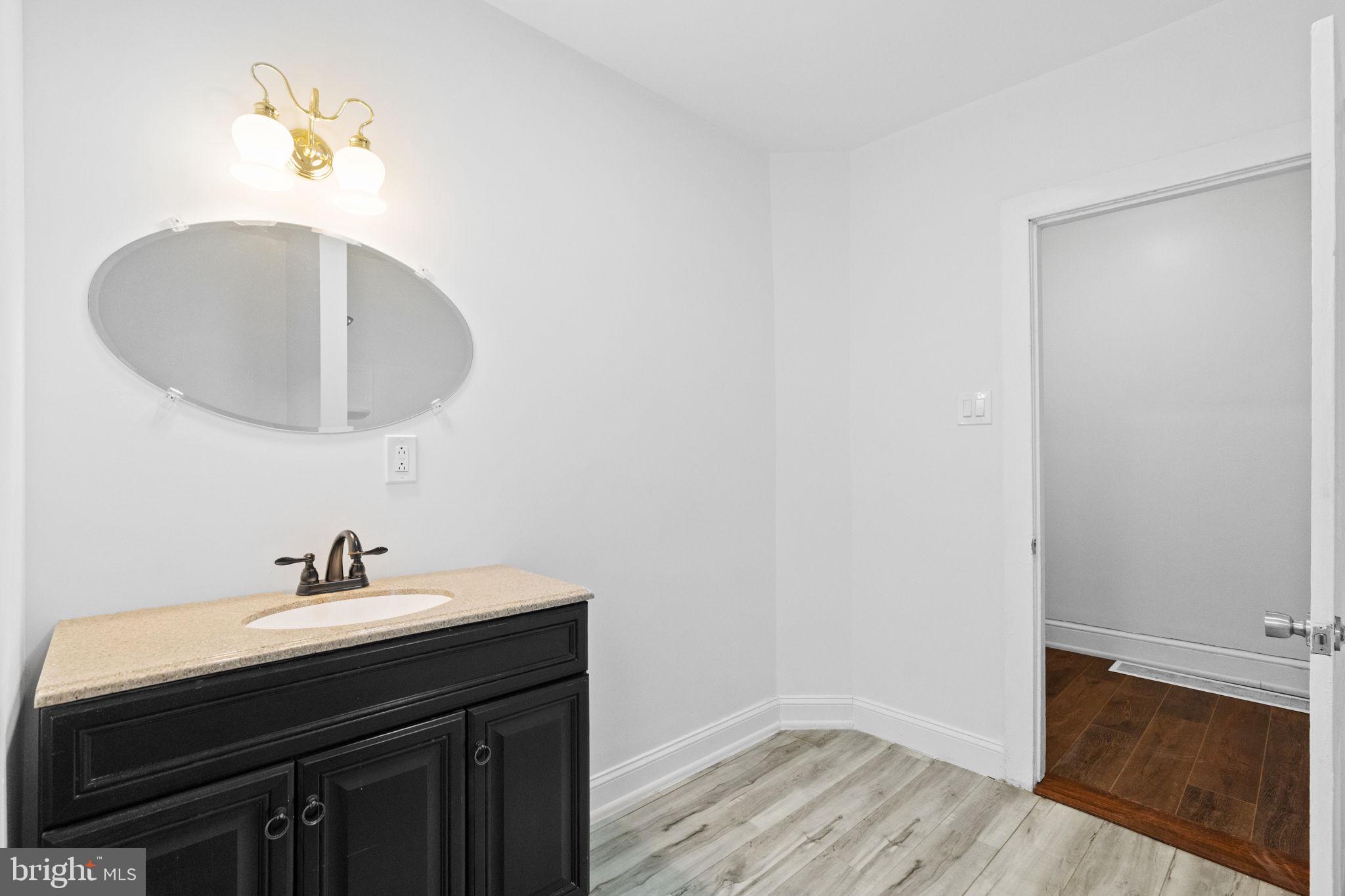 620 George Street Norristown, PA 19401 - Photo 31 of 53 a bathroom with a sink a light fixture and a mirror