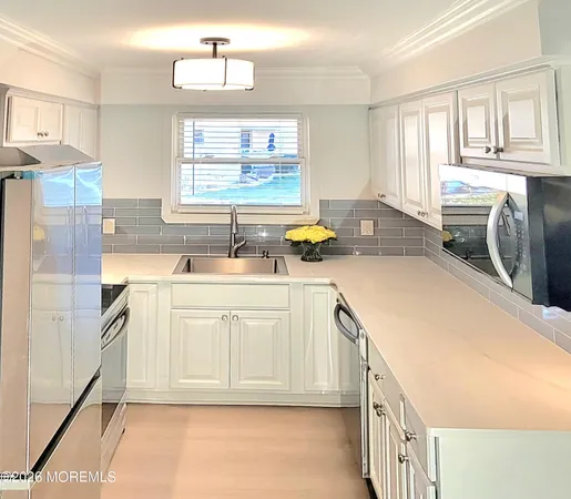 a kitchen with a sink stove and cabinets