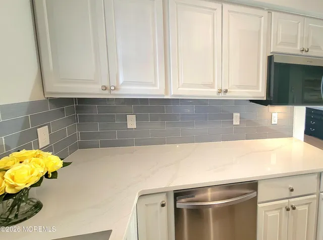 a kitchen with a stove a sink and a bathtub