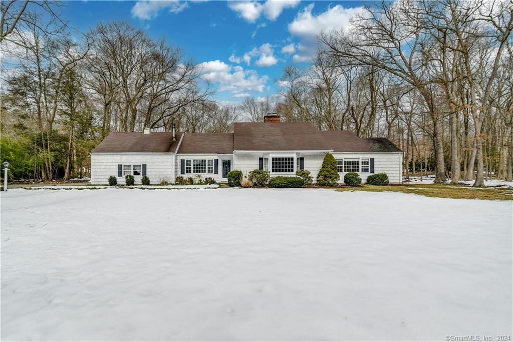 a front view of a house with a road