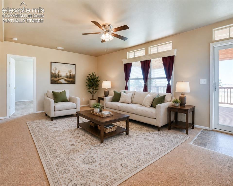 22558 Enoch Road Calhan, CO 80808 - Photo 5 of 50 a living room with furniture and a large window