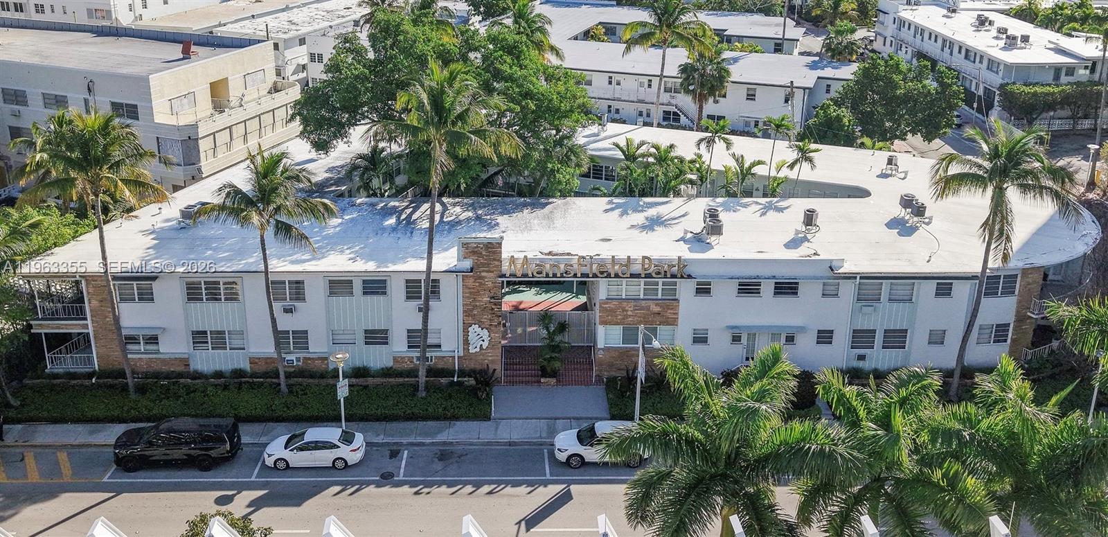 1925 Washington Avenue, Unit 21 Miami Beach, FL 33139 - Photo 1 of 16 a view of a building with garden and tall buildings