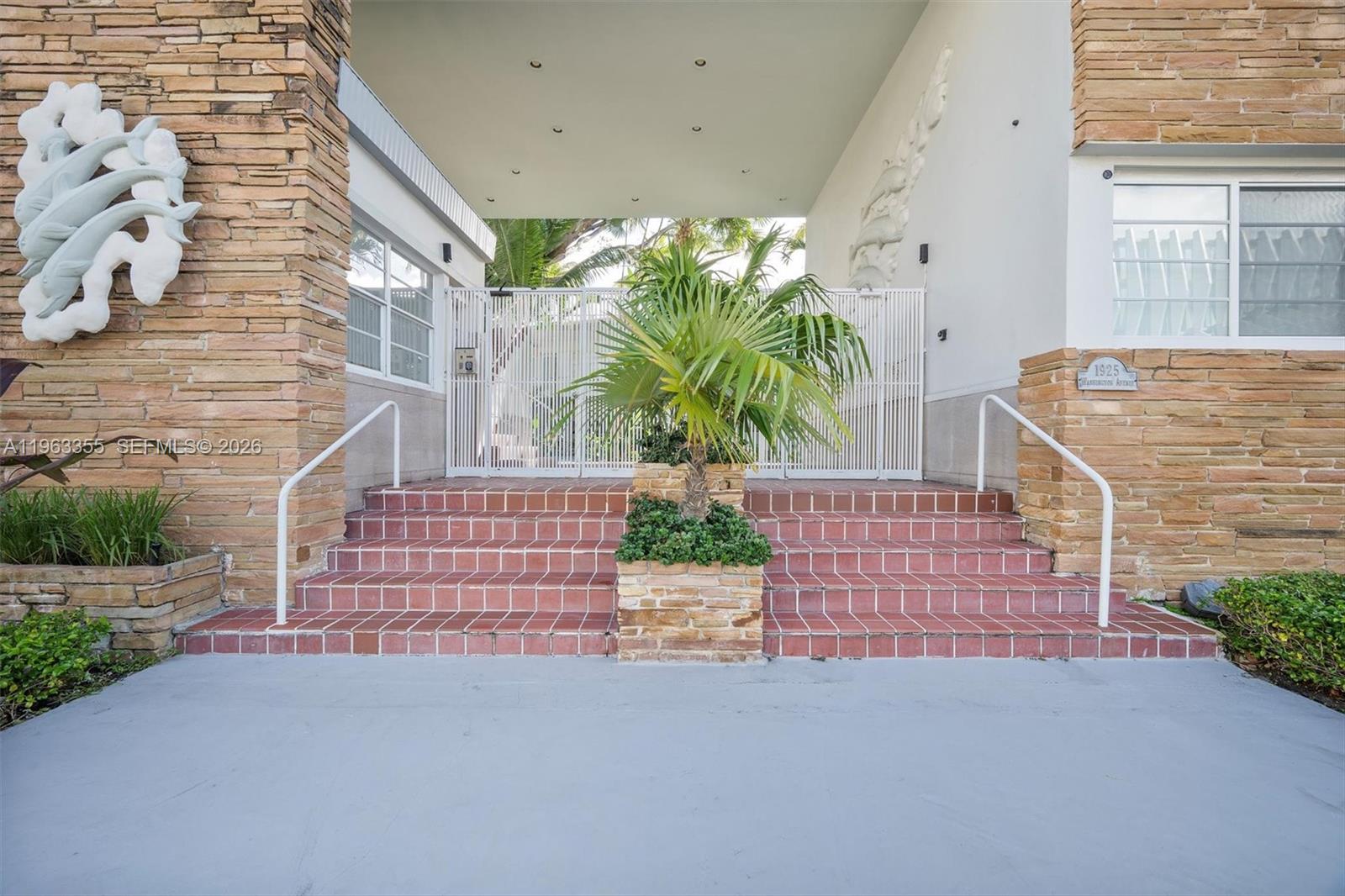 1925 Washington Avenue, Unit 21 Miami Beach, FL 33139 - Photo 3 of 16 a front view of a house with a garden