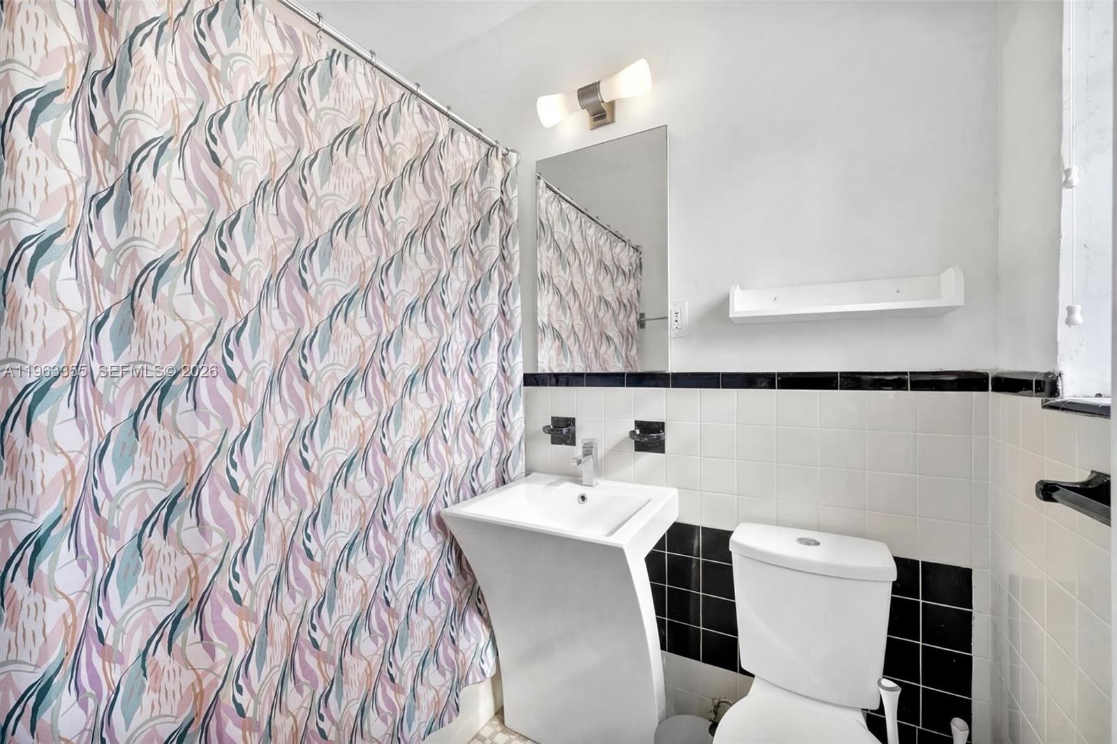 1925 Washington Avenue, Unit 21 Miami Beach, FL 33139 - Photo 9 of 16 a bathroom with a sink and a mirror