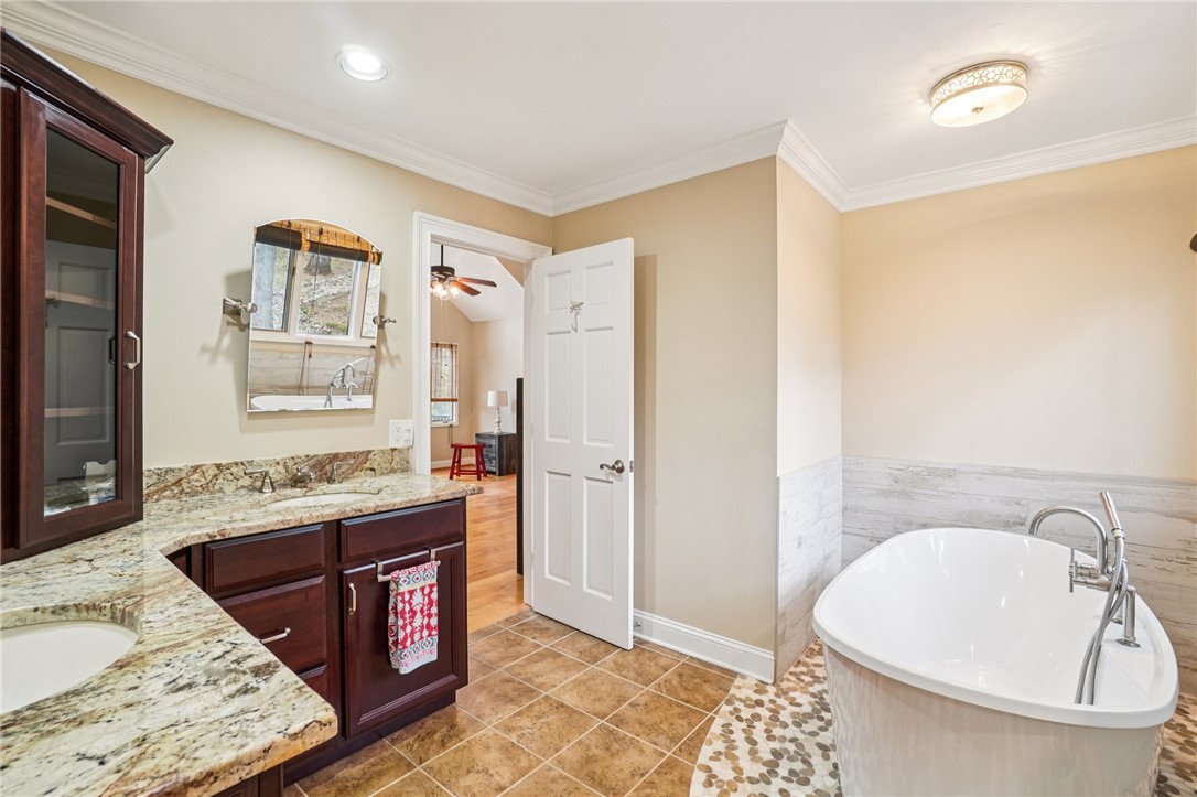 120 Beacon Ridge Circle Salem, SC 29676 - Photo 22 of 48 This serene bathroom offers a luxurious soaking tub, dual vanity with granite counters, and elegant crown molding.
