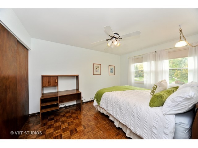 439 Weidner Road Buffalo Grove, IL 60089 - Photo 11 of 23 a bedroom with a bed and a chandelier