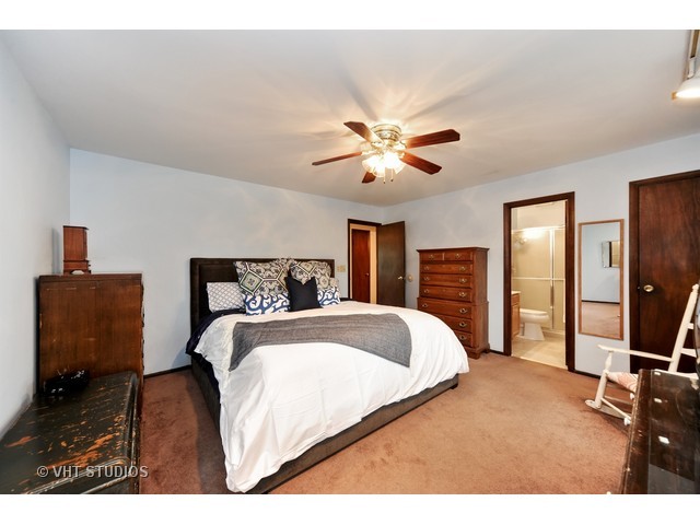 439 Weidner Road Buffalo Grove, IL 60089 - Photo 8 of 23 a bedroom with a large bed and a tv