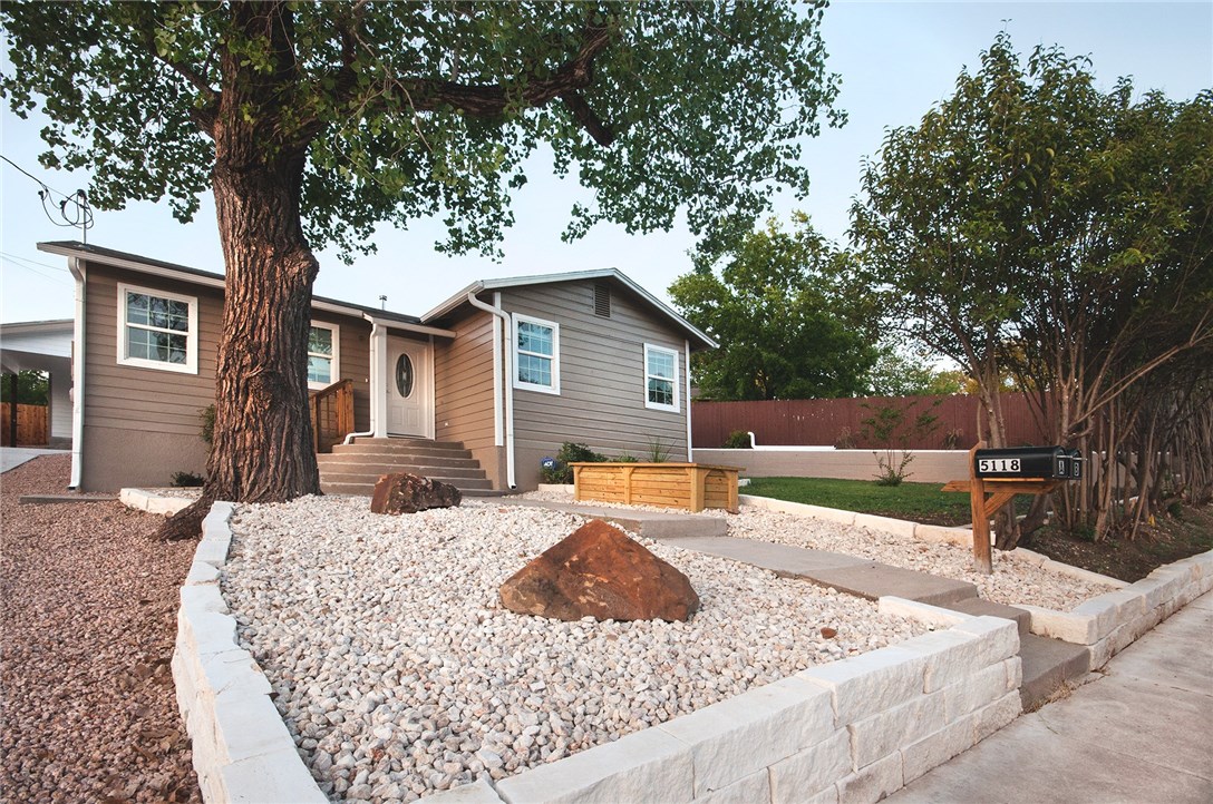 a view of a house with backyard porch and sitting area