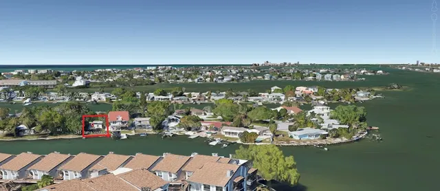 a view of a lake with boats and trees in the background
