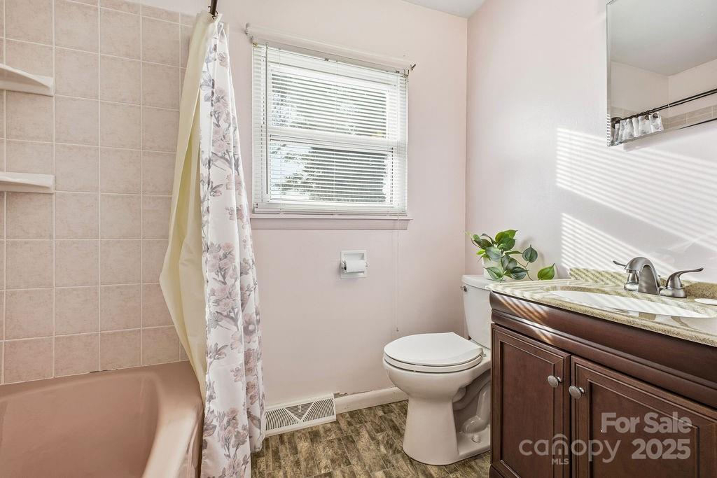 50 Huffman Road Asheville, NC 28806 - Photo 15 of 19 a bathroom with a granite countertop toilet sink and mirror