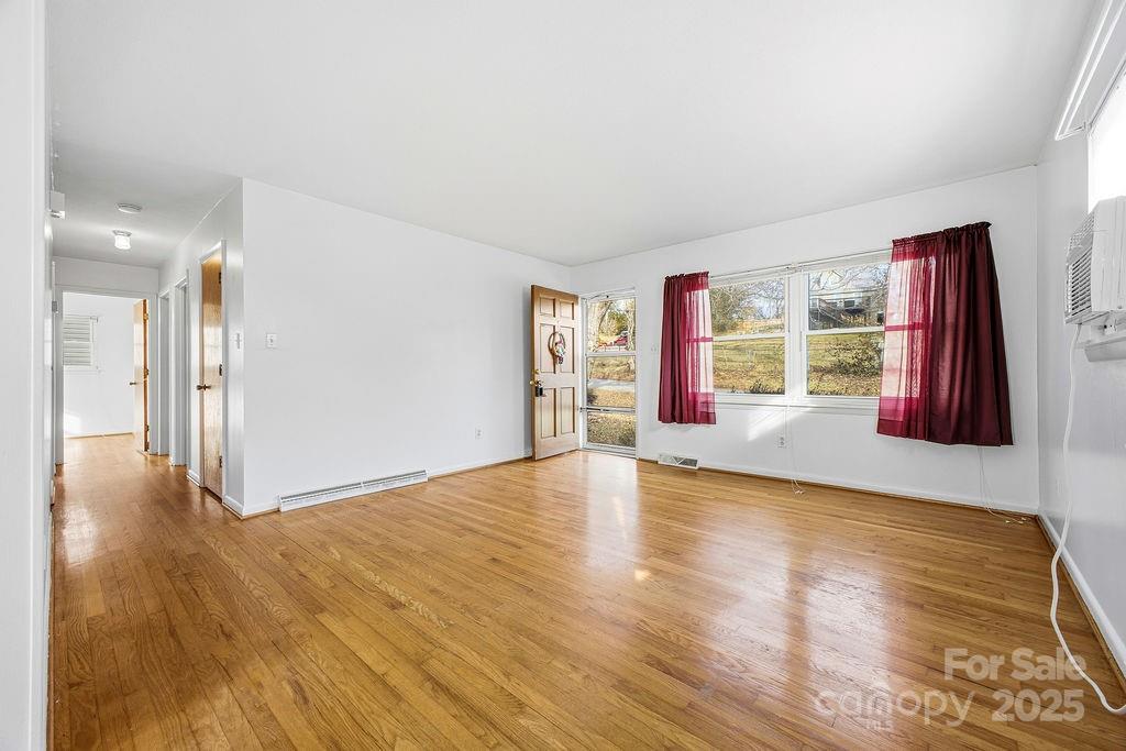 50 Huffman Road Asheville, NC 28806 - Photo 2 of 19 a view of an empty room with window and wooden floor