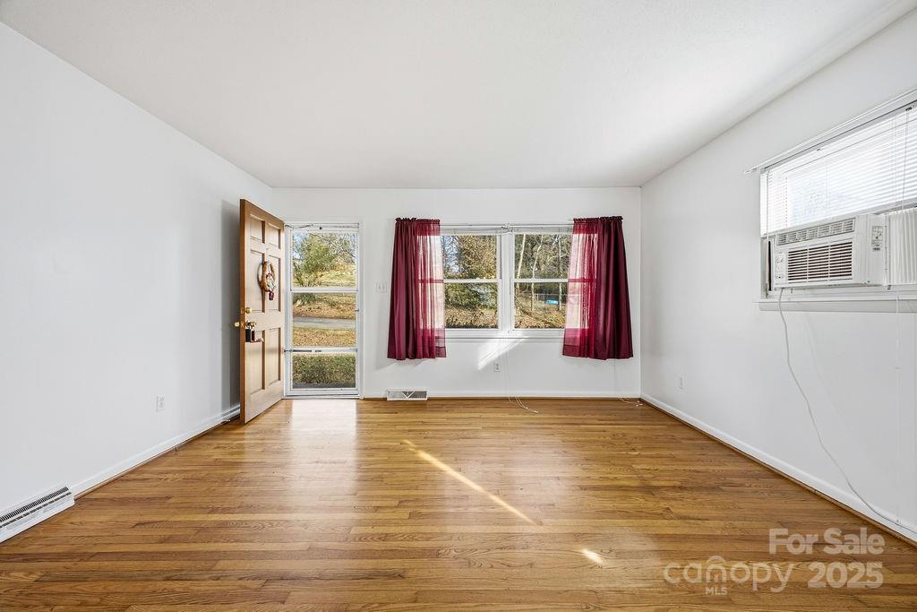50 Huffman Road Asheville, NC 28806 - Photo 3 of 19 wooden floor in an empty room with window