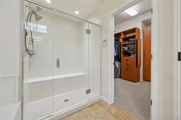 a bathroom with a shower and a glass door