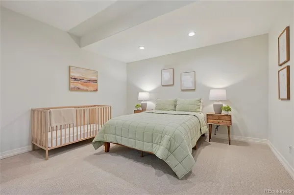 a bedroom with a bed and a couch