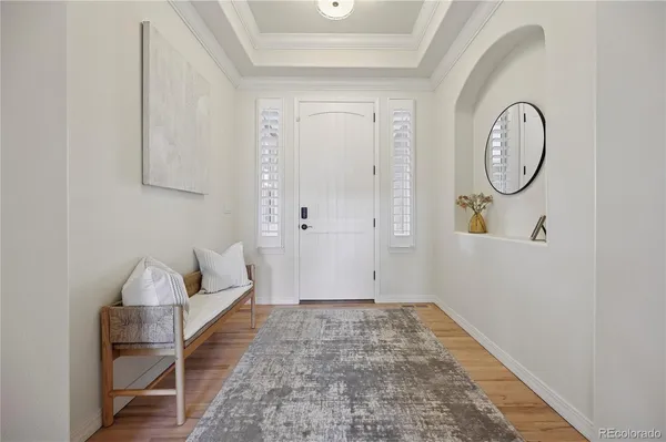 a view of a livingroom with wooden floor and a rug