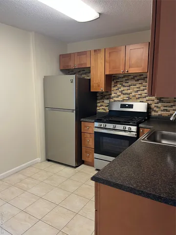 a kitchen with a stove and a refrigerator