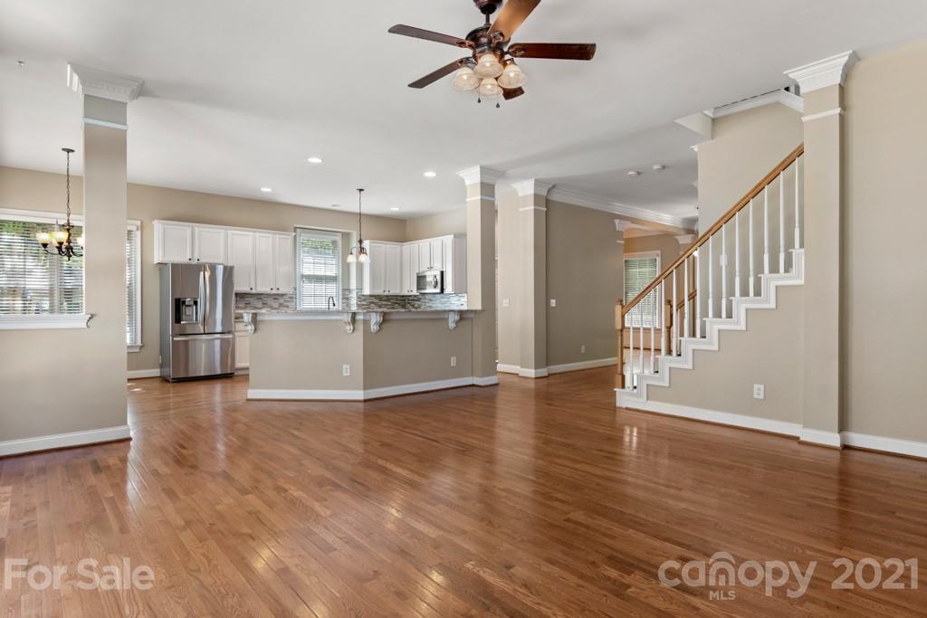 3272 Richard's Crossing, Unit 247 Fort Mill, SC 29708 - Photo 14 of 38 a view of a kitchen with a refrigerator a ceiling fan and wooden floor