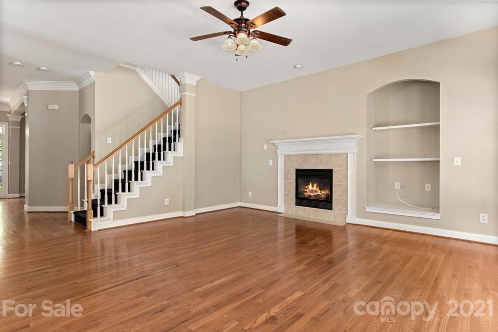 3272 Richard's Crossing, Unit 247 Fort Mill, SC 29708 - Photo 15 of 38 a view of an empty room with wooden floor fireplace and a window