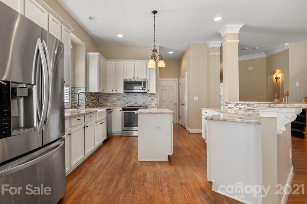 3272 Richard's Crossing, Unit 247 Fort Mill, SC 29708 - Photo 17 of 38 a kitchen with white cabinets and stainless steel appliances