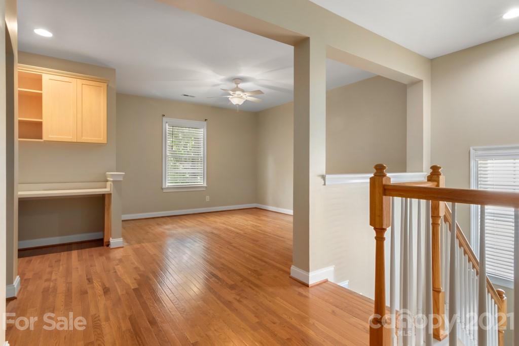 3272 Richard's Crossing, Unit 247 Fort Mill, SC 29708 - Photo 22 of 38 a view of an empty room with a window and wooden floor