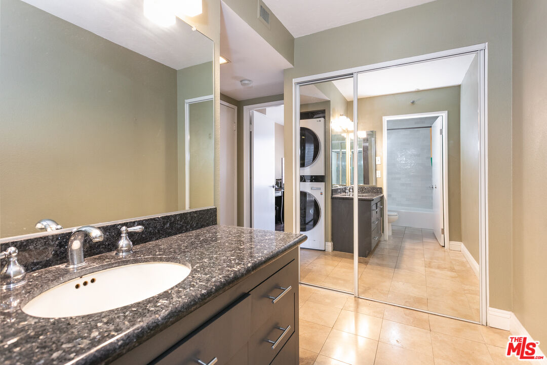 600 West 9th Street, Unit 810 Los Angeles, CA 90015 - Photo 12 of 24 a bathroom with a granite countertop sink and a mirror