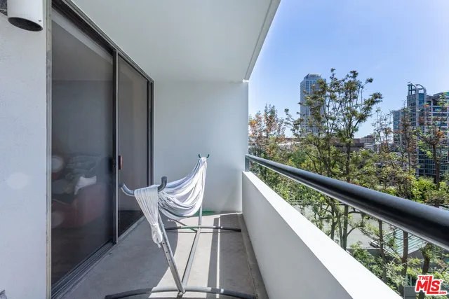 a balcony with wooden floor and outdoor seating