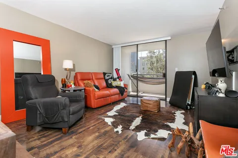 a living room with furniture fireplace and a large window