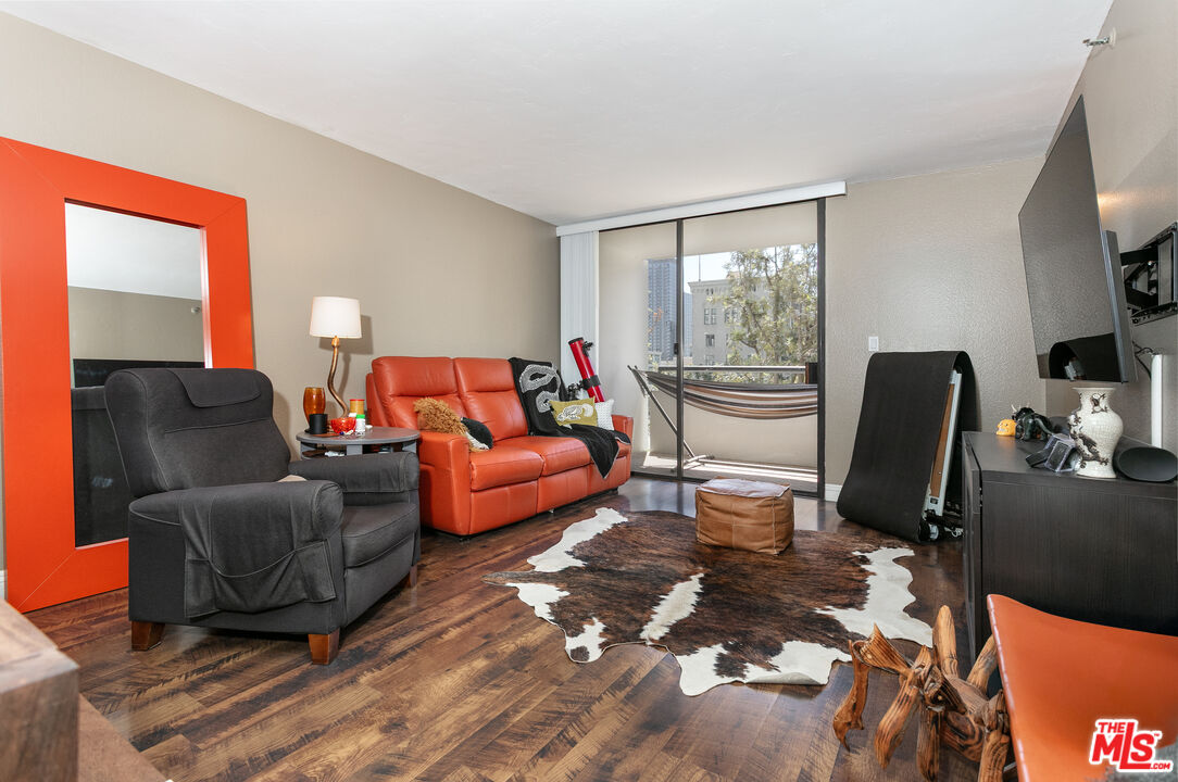 600 West 9th Street, Unit 810 Los Angeles, CA 90015 - Photo 2 of 24 a living room with furniture fireplace and a large window