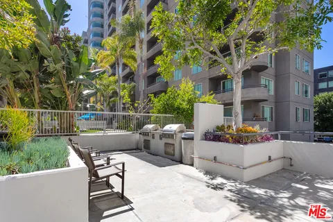 a view of backyard with outdoor seating and plants