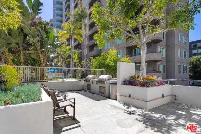 a view of backyard with outdoor seating and plants