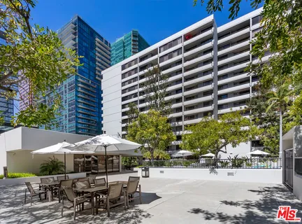 a patio with a table and chairs under an umbrella