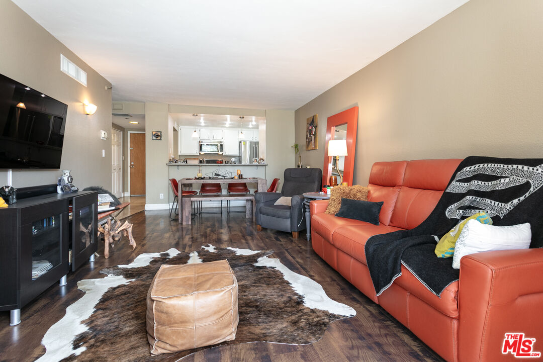 600 West 9th Street, Unit 810 Los Angeles, CA 90015 - Photo 4 of 24 a living room with furniture and a flat screen tv