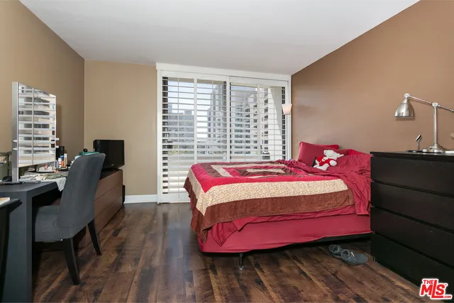 a bedroom with a bed chair and a window