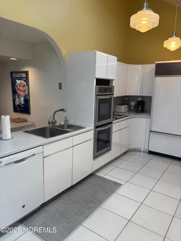 a kitchen with stainless steel appliances granite countertop a sink and a stove