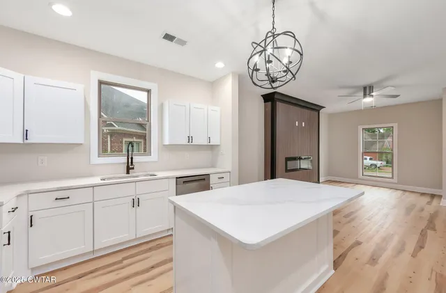 a very nice looking kitchen with a large window