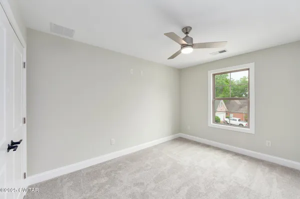 a view of an empty room with a window