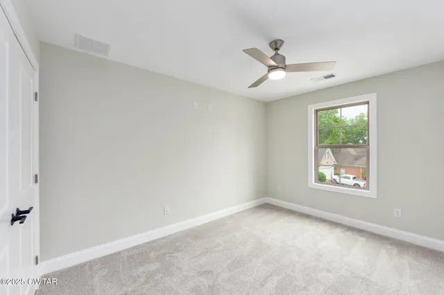 a view of an empty room with a window