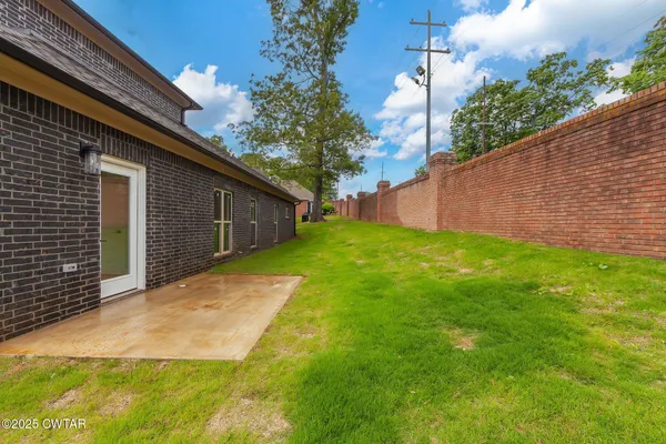 a view of backyard of house with green space