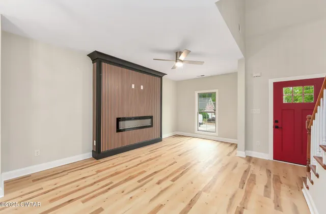 a view of empty room with wooden floor