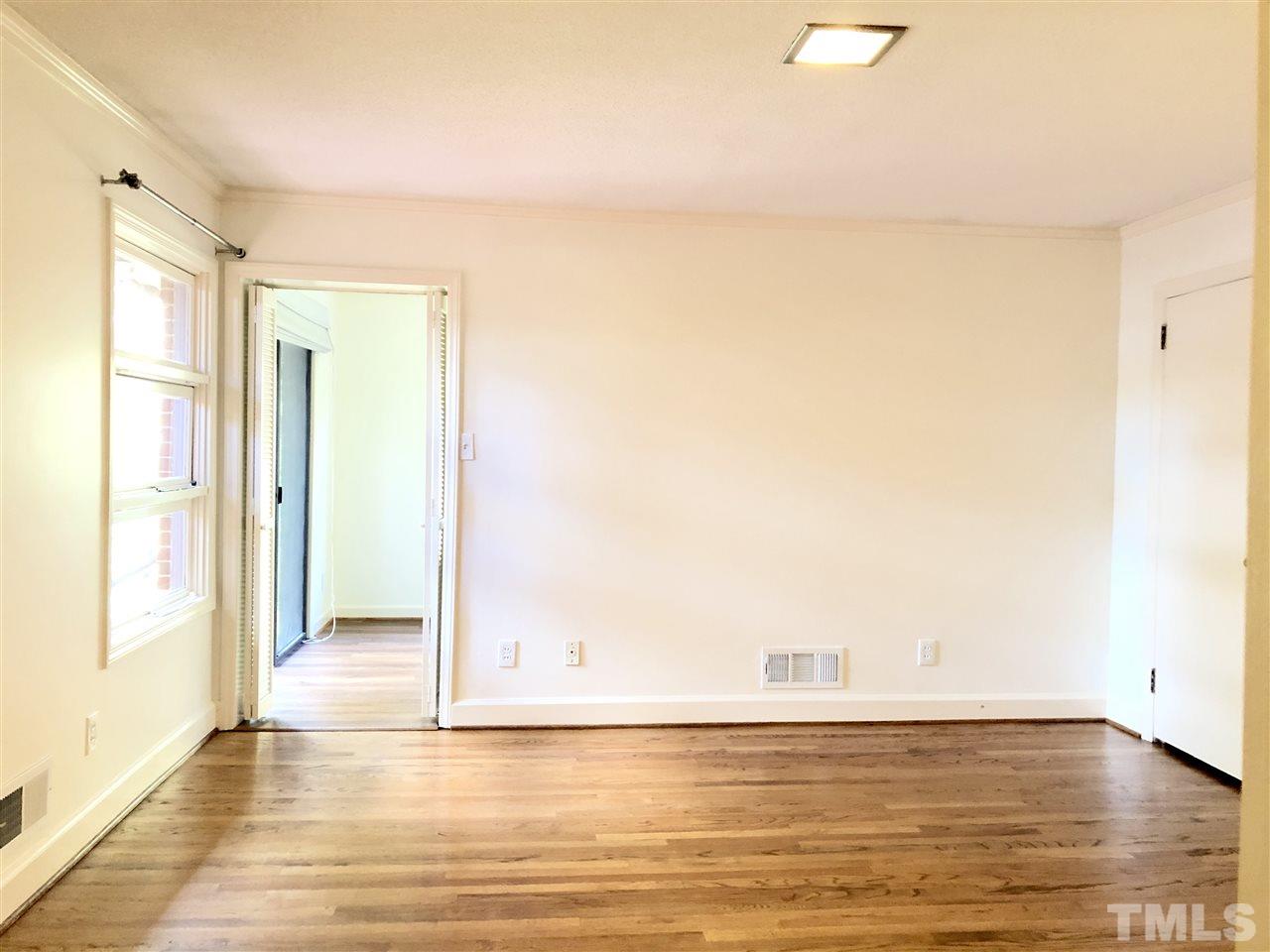 521 Buck Jones Road Raleigh, NC 27606 - Photo 15 of 30 a view of empty room with wooden floor