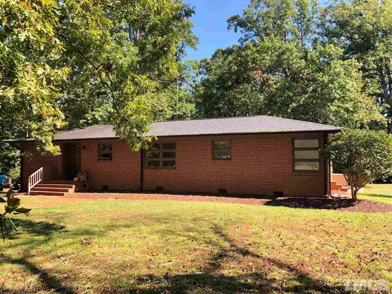 521 Buck Jones Road Raleigh, NC 27606 - Photo 3 of 30 a house with yard in front of it