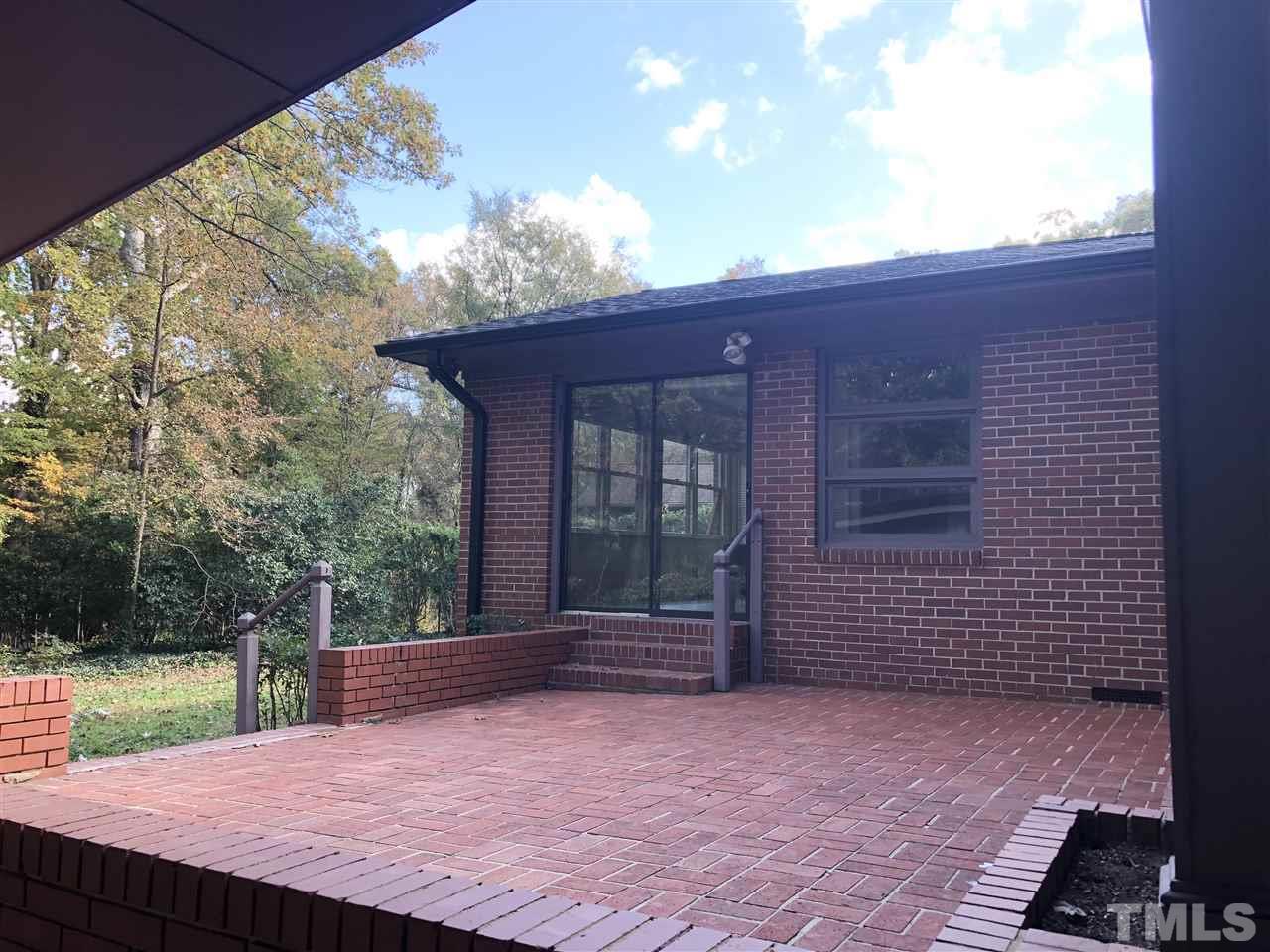 521 Buck Jones Road Raleigh, NC 27606 - Photo 21 of 30 a backyard of a house with barbeque oven and bench