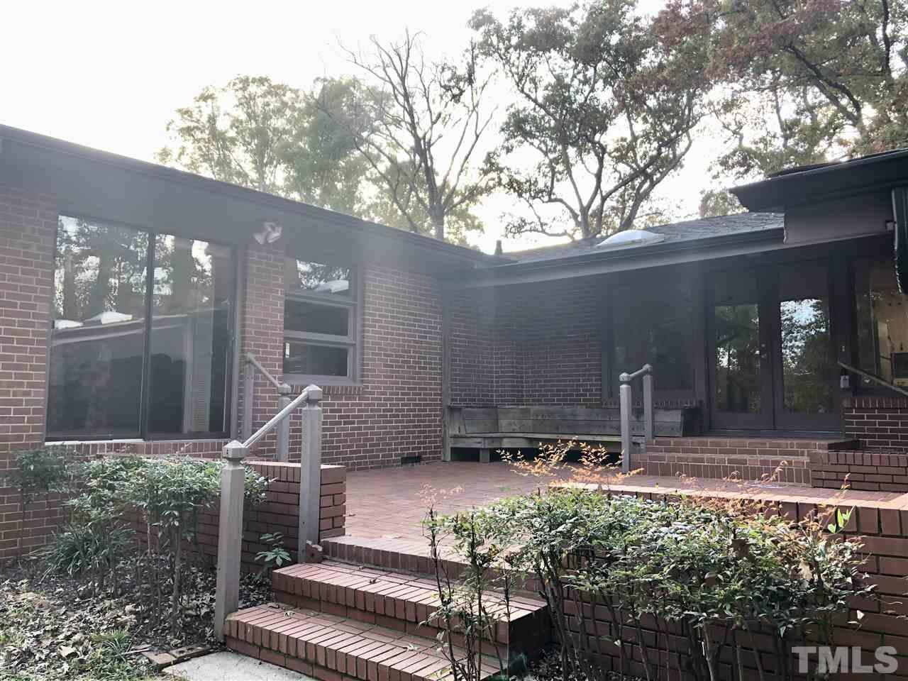 521 Buck Jones Road Raleigh, NC 27606 - Photo 23 of 30 a front view of a house with a yard