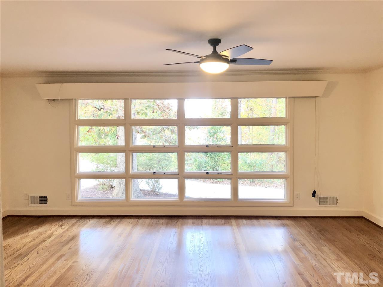 521 Buck Jones Road Raleigh, NC 27606 - Photo 4 of 30 a view of a ceiling fan and wooden floor