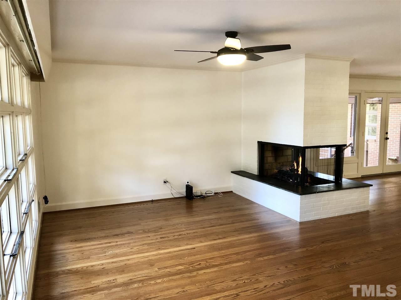 521 Buck Jones Road Raleigh, NC 27606 - Photo 5 of 30 a view of fireplace and wooden floor