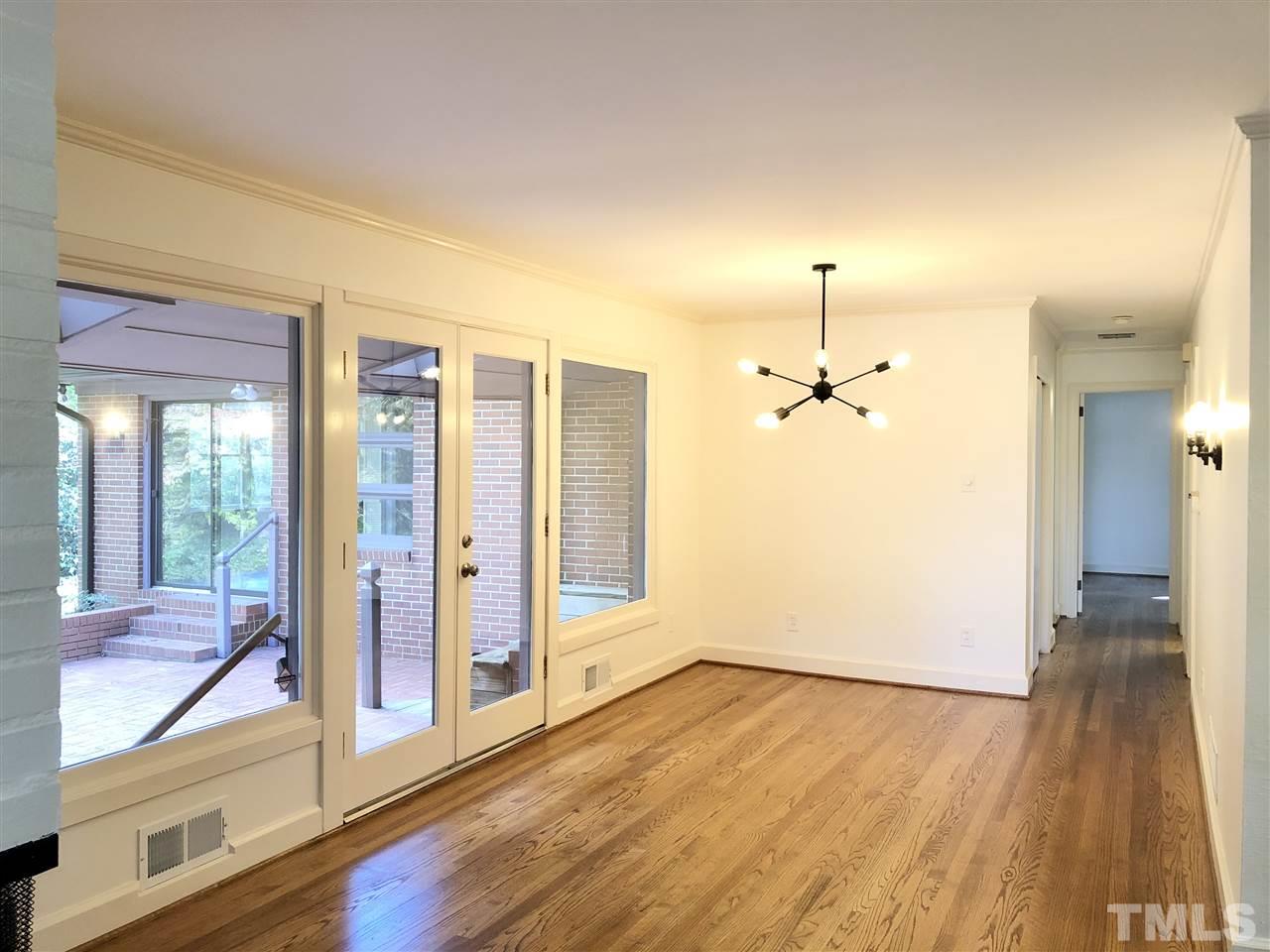 521 Buck Jones Road Raleigh, NC 27606 - Photo 8 of 30 a view of a hallway with wooden floor and cabinet